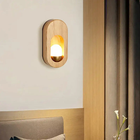 Warm-toned oval led wooden wall lamp decorbites with smooth natural grain and amber light for bedroom decor