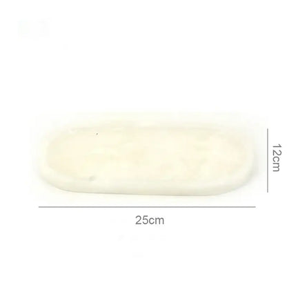 Cream-colored oval white Calacatta marble vanity tray with smooth textured surface and rounded edges for bathroom decorbites Calacatta marble use