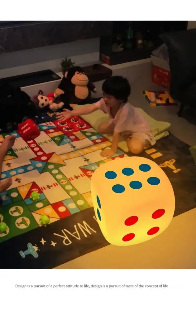 A glowing yellow oversized dice night lamp with blue and red dots featuring colorful remote control for bedroom decor