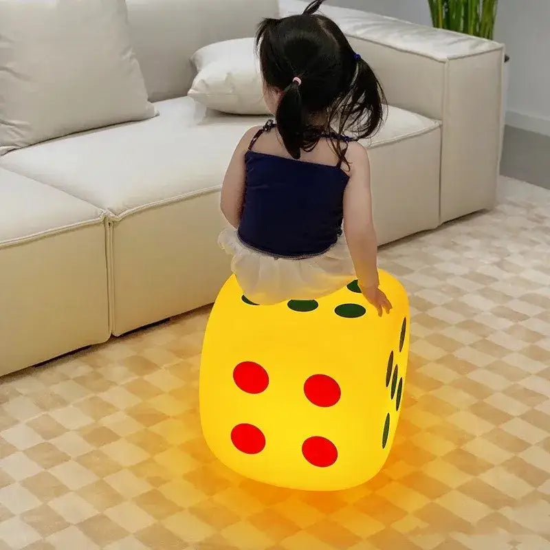 A glowing yellow oversized dice night lamp with red and green dots featuring colorful remote control for bedroom decor