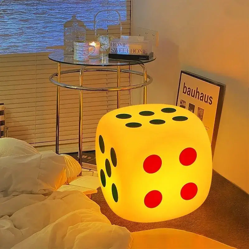 A glowing yellow oversized dice night lamp with red and black dots featuring colorful remote control decorbites