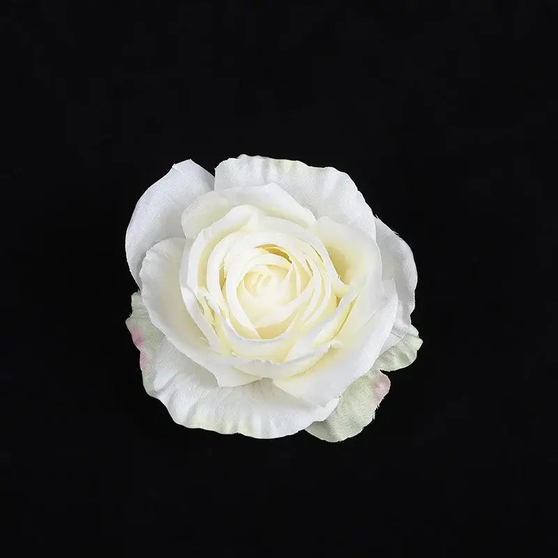 A delicate white silk rose with pale yellow center from 30pcs silk roses set for wedding and living room decor