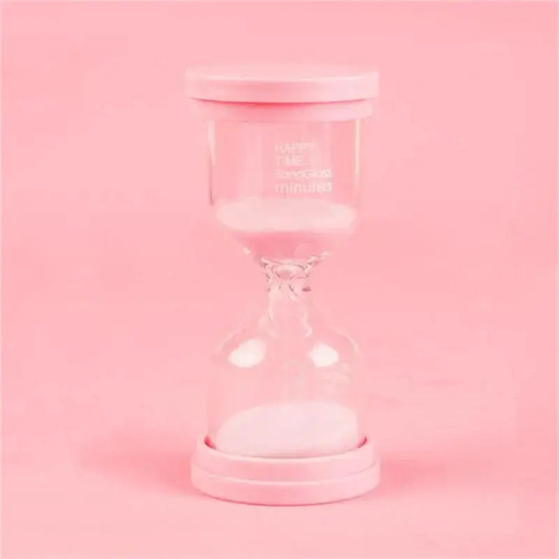 Pink glass hourglass with white sand and pink lid from a pastel blue and pink sand timer set for kids bedroom decor