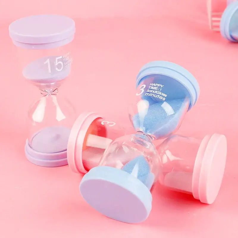 Pastel blue and pink sand timer set for kids bedroom decor with translucent glass bodies and blue sand design