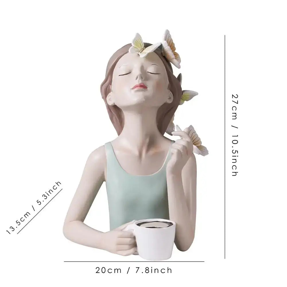 A serene light green butterfly fairy resin figurine with closed eyes holding a white mug on a gold tray decorbites decor