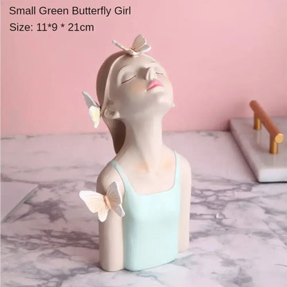 A delicate resin butterfly girl figurine with white butterflies on a pastel butterfly girl flower vase for living room decor