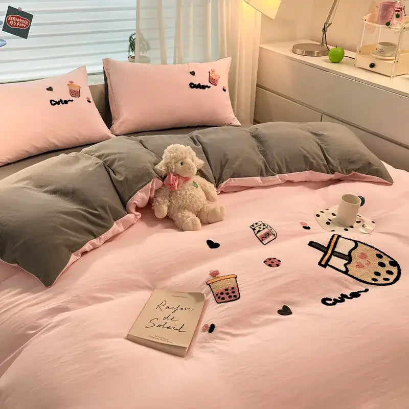 Pink satin-like comforter from pastel cartoon embroidered cotton bedding set with embroidered bubble tea and heart designs