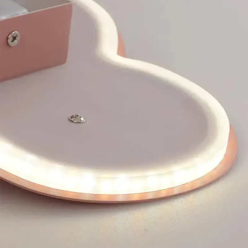 A sleek rose gold heart-shaped wall lamp with glowing white edge for decorbites cloud led kids bedroom lighting