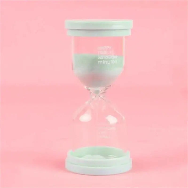 A mint green plastic-capped glass hourglass sand timer with clear body and printed text for kids bedroom decorbites hourglass sand