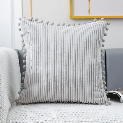 Gray corduroy pompom cushion cover with soft vertical ridges and matching pom-poms for living room decorbites decor