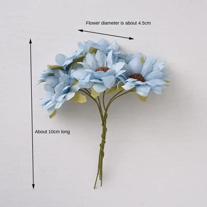 A delicate pastel decorbites daisy sunflower bouquet of light blue artificial flowers with brown centers for wedding decor