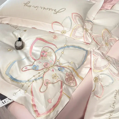 Delicate ivory satin bedding set with pastel decorbites embroidered butterfly flowers in pink blue and gold thread detailing