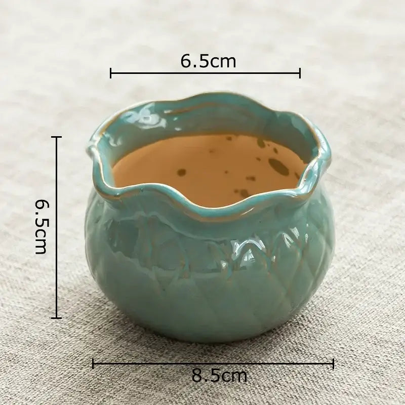A small round lotus flower ceramic tea cup with teal glaze and scalloped rim for decorbites lotus flower decor