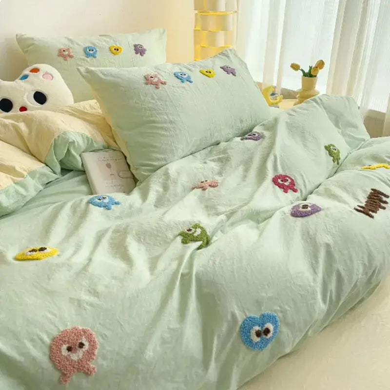 Pastel green bedding set with decorbites cartoon embroidery and colorful plush appliqués for bedroom comforter use