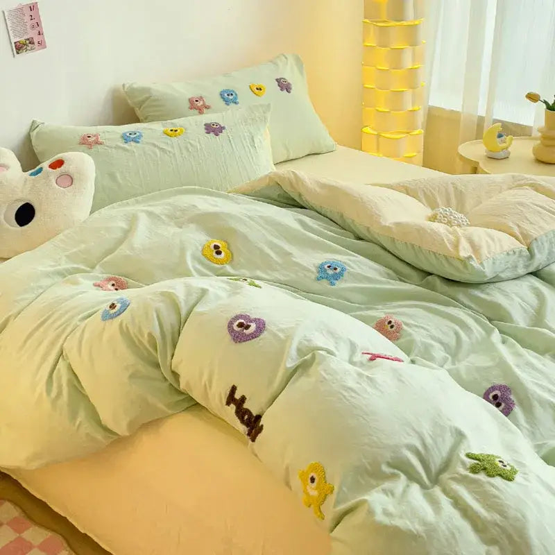 Pastel green quilted bedding set with colorful decorbites cartoon embroidery featuring monsters and hearts designs