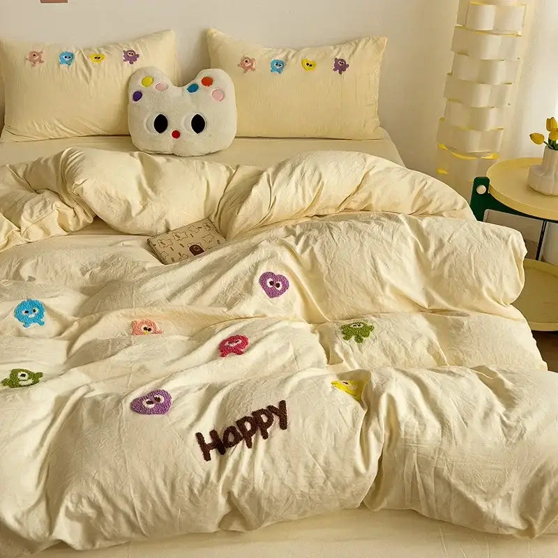 Cream-colored quilted duvet bedding set with colorful cartoon towel embroidery and happy word for decorbites cartoon towel decor