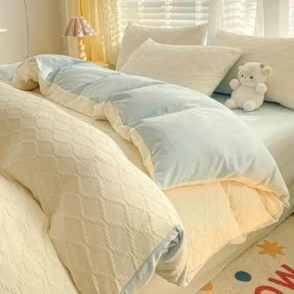 Cream-colored quilted duvet cover with light blue lining and matching pillows from decorbites fresh bubble yarn bedding set