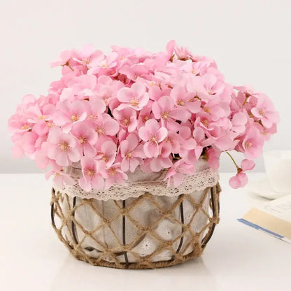 A pastel pink begonia flower dry arrangement with dry flower embossing in a wicker basket for living room decor