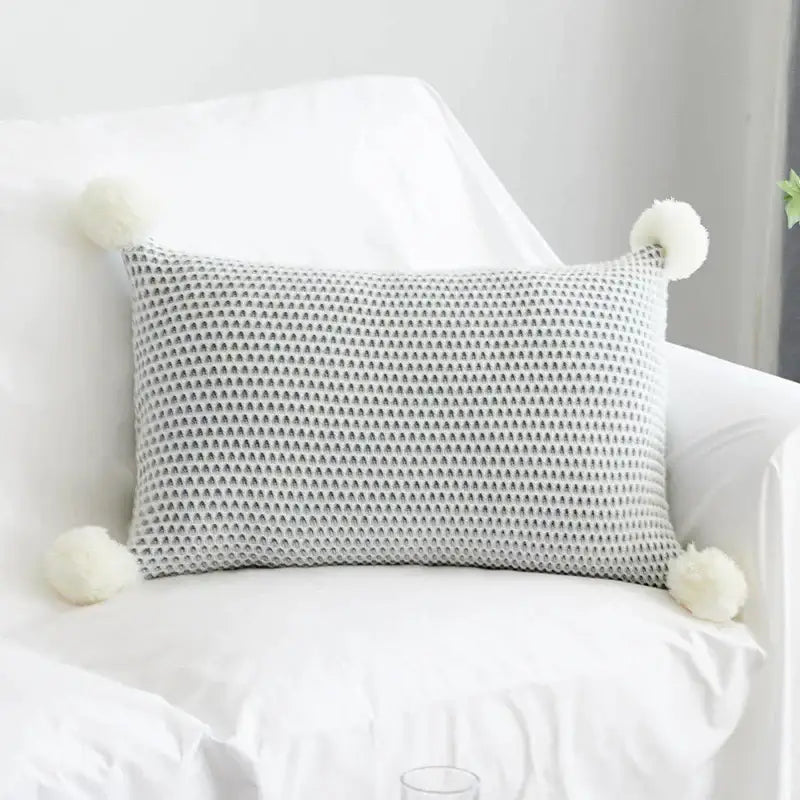 Gray knitted rectangular cushion cover with white knit pompom ball accents for decorbites knit pompom bedroom decor