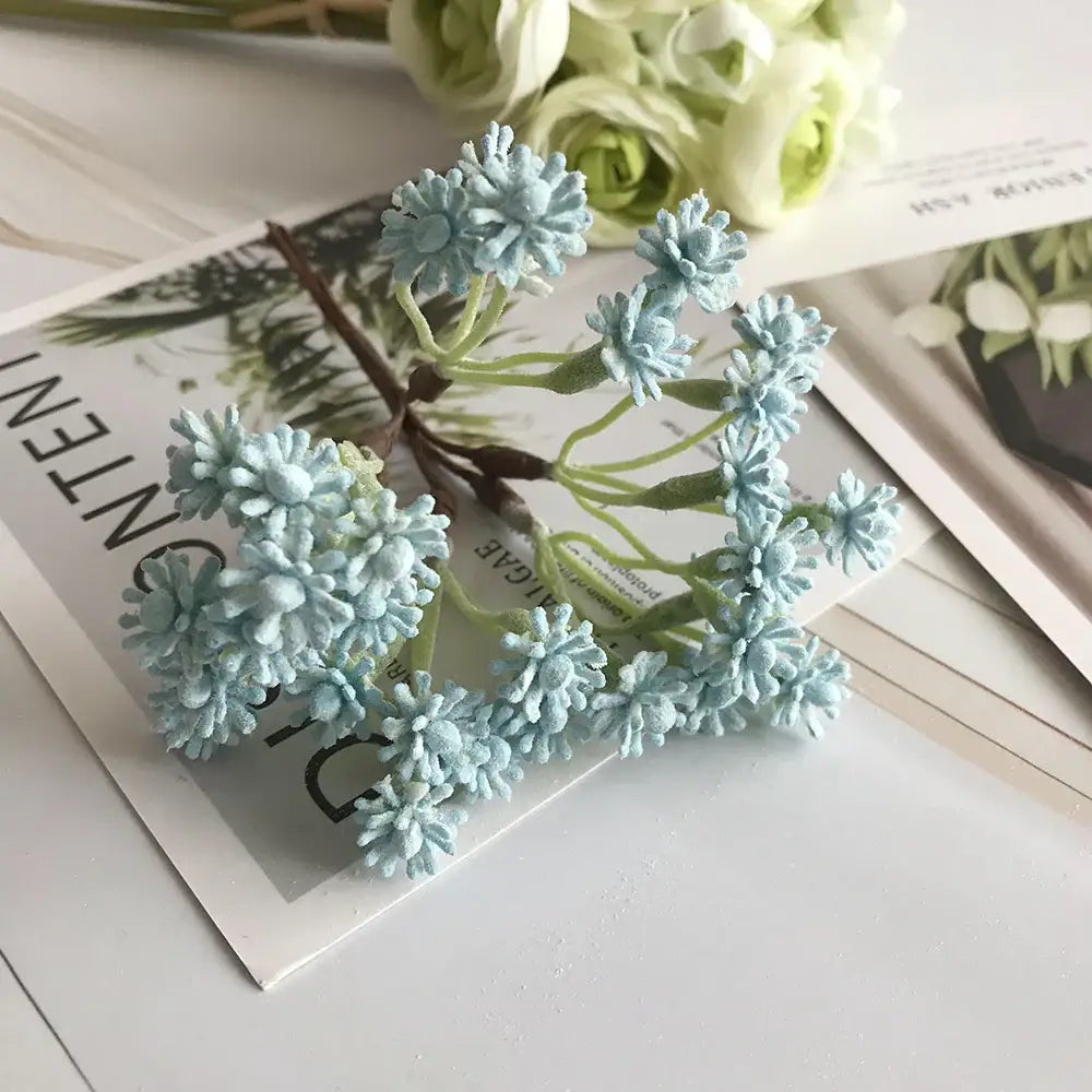 A pastel multi color decorative vase set featuring a delicate cluster of light blue artificial flowers with green stems decorbites decorative vase