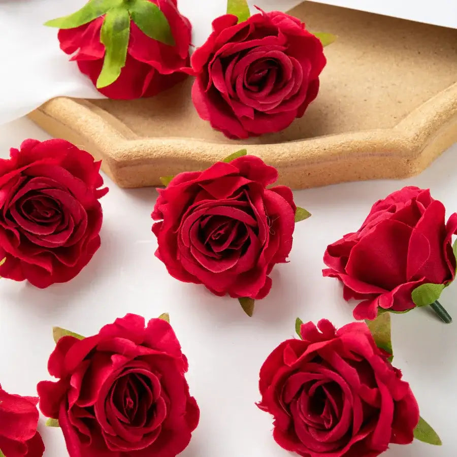 Vibrant red artificial flowers with green stems and leaves made of soft fabric part of decorbites 100pcs multicolor silk set
