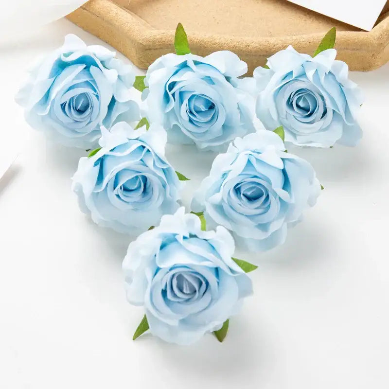 Delicate light blue artificial flowers with soft layered petals and small green stems in decorbites 100pcs multicolor silk set
