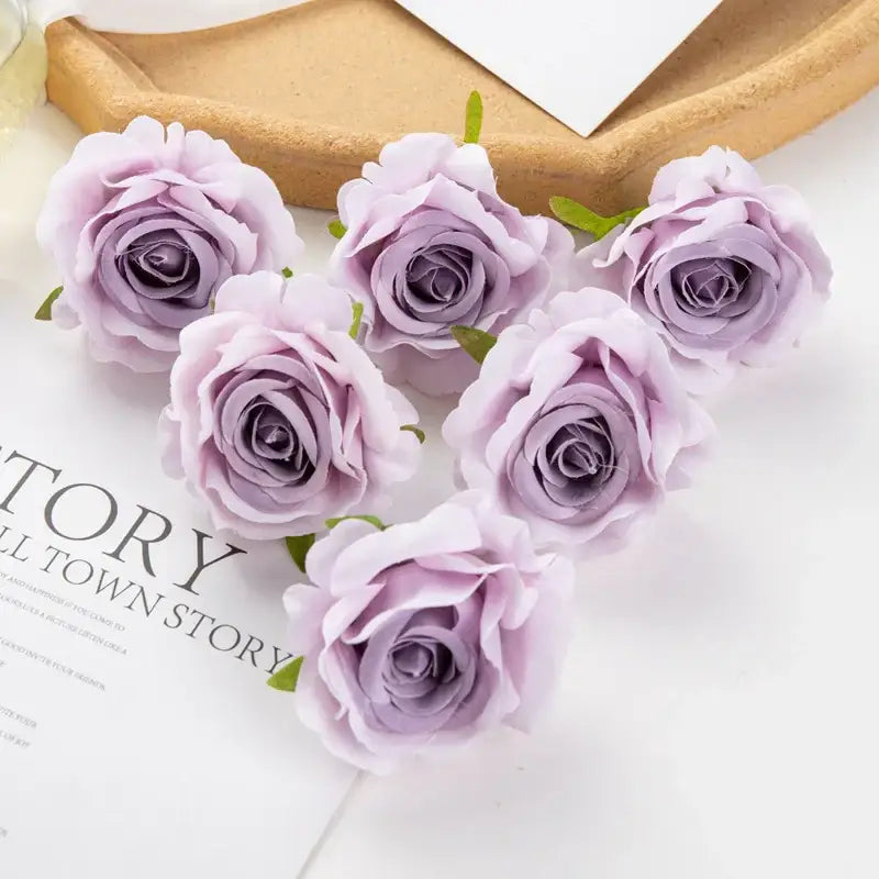 Six delicate lavender artificial flowers with soft petals and green stems arranged in a heart shape decorbites 100pcs multicolor silk
