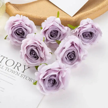 Six delicate lavender artificial flowers with soft petals and green stems arranged in a heart shape decorbites 100pcs multicolor silk