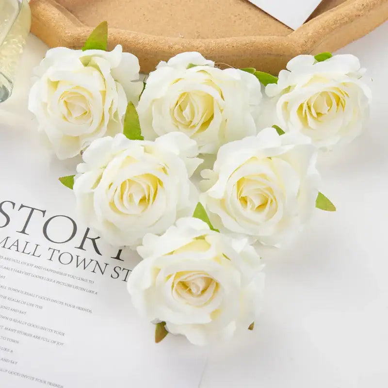 White artificial flowers with delicate yellow centers and green stems in decorbites 100pcs multicolor silk wedding decor