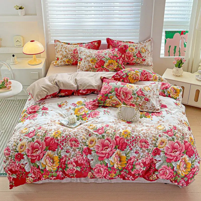 Floral-patterned pastel pink and cream decorbites cozy cotton bedding set with vibrant blossoms on a white background