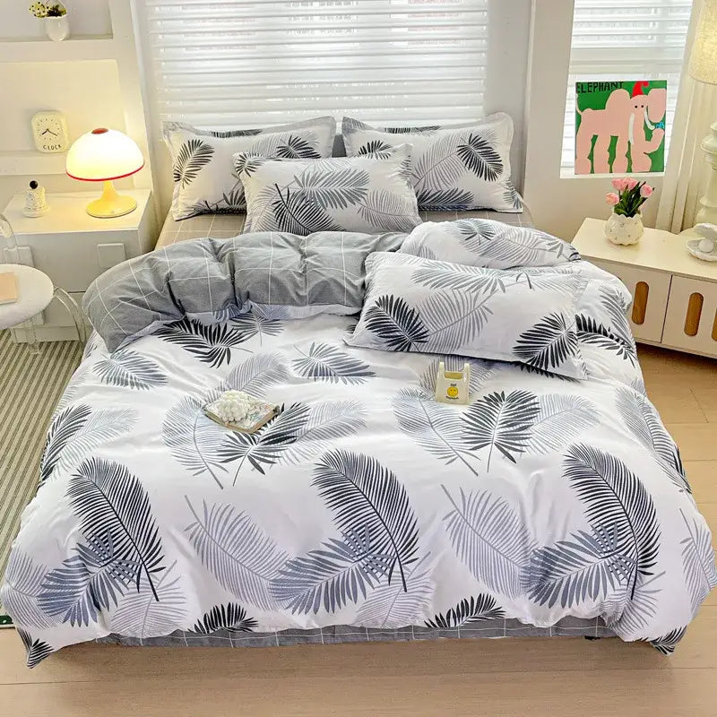 White duvet cover with tropical palm leaf pattern in gray and black featuring matching pillowcases from decorbites cozy cotton bedding set