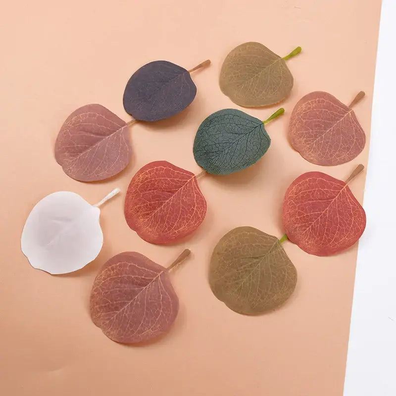 A collection of pastel pink and green silk leaf artificial plants in translucent silk for home decor living room accents