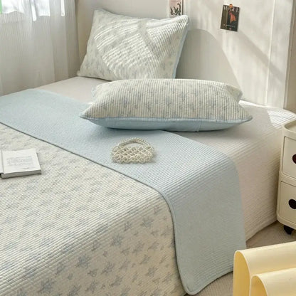 Light blue quilted cotton bed cover with subtle floral pattern designed as a soft anti slip tatami mat runner
