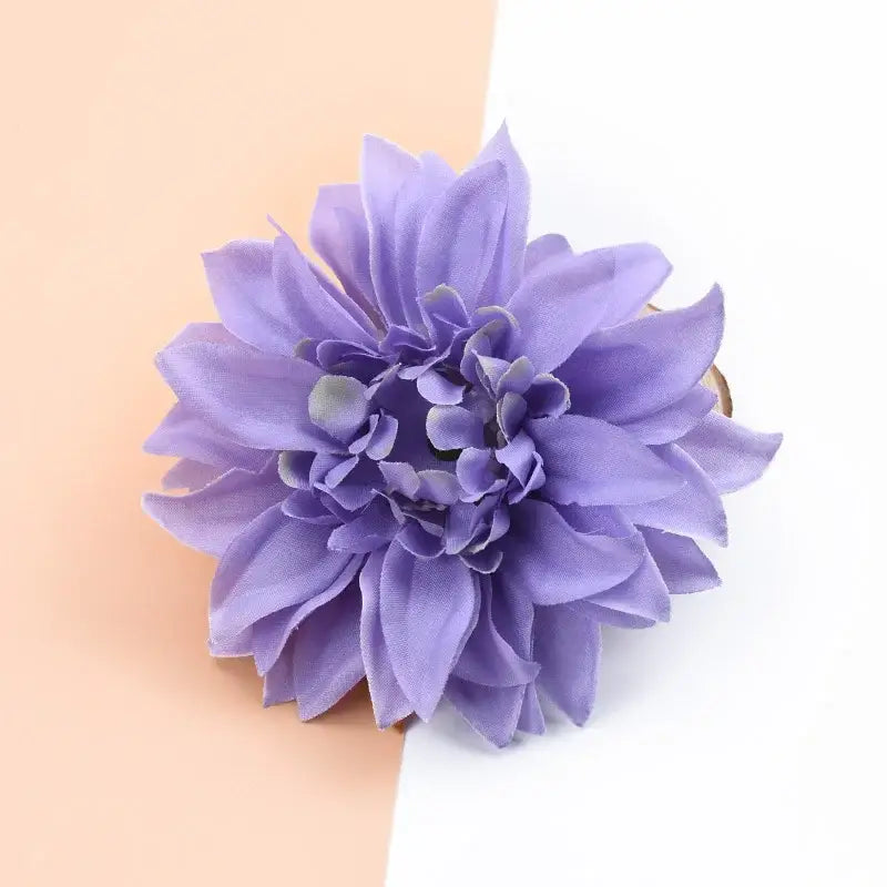A delicate lavender silk gerbera flower hair clip with layered petals for wedding and living room decor