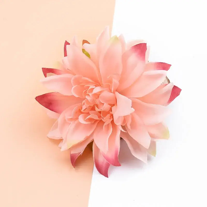 A delicate peach-colored artificial silk gerbera flower with soft layered petals and subtle pink tips for decor