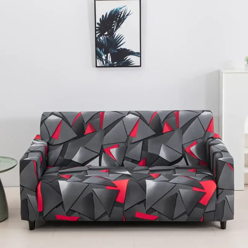 A sleek gray and red geometric-patterned stretch sofa cover for living room with modern angular design