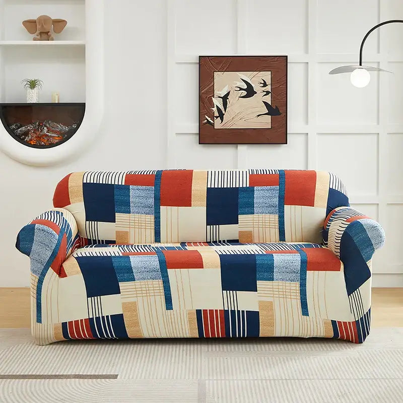 A cozy two-seater sofa with a stretchy patchwork mandala printed slipcover in red navy blue beige and cream colors