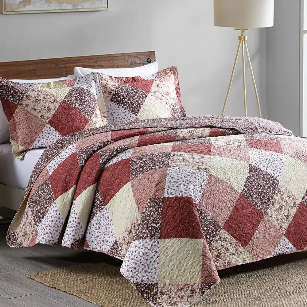 Quilted patchwork coverlet bedding set in rust cream and muted brown with geometric diamond and floral motifs