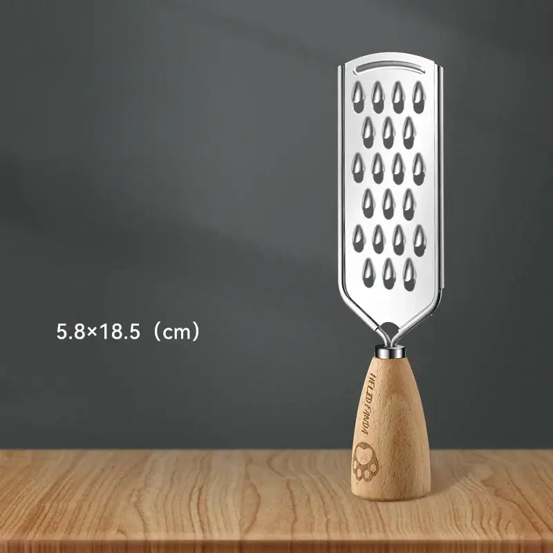 A sleek stainless steel 3-in-1 multifunctional grater with a wooden handle and engraved paw print hua jia tian text