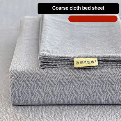 Gray coarse cloth bed sheet with textured weave and yellow label in peach and cream geometric bed sheet set