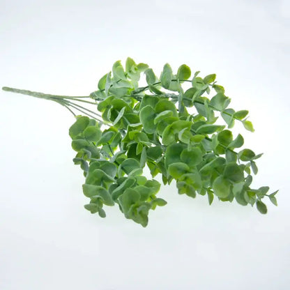 A lush artificial eucalyptus leaves sprig with vibrant green leaves in a peach and green decorbites living room vase arrangement
