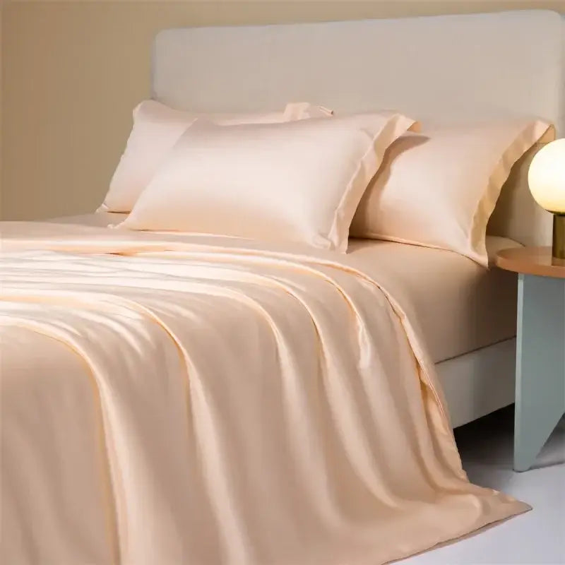 Cream-colored satin bedding set with cooling cotton solid fabric and matching pillows for a smooth bedroom look