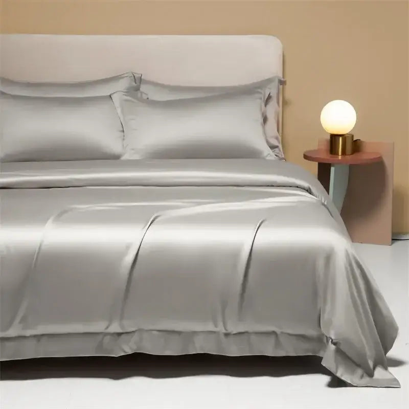 Silk satin duvet cover set in soft silver with elegant pleats and smooth finish for peach satin cooling cotton solid bedding set