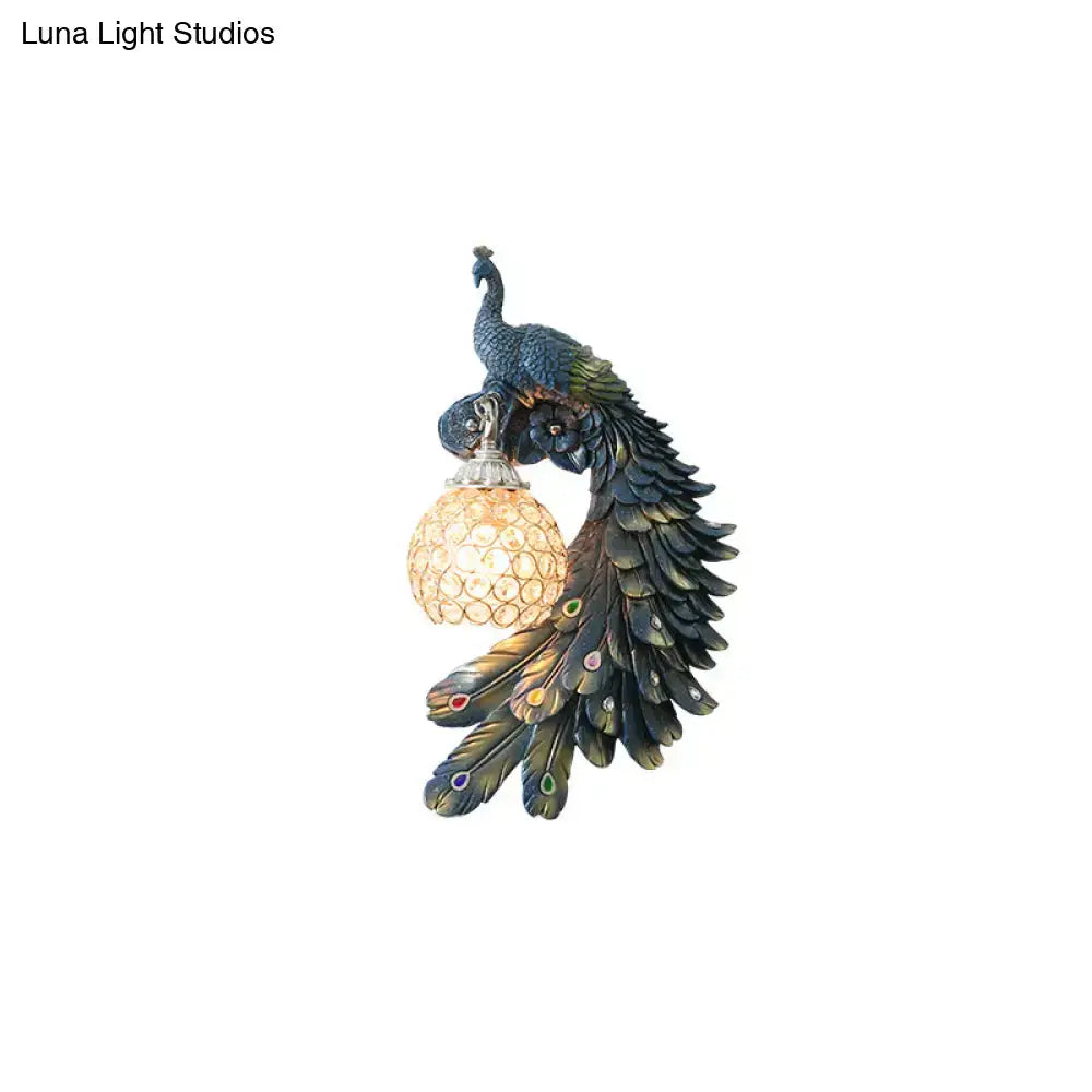 Peacock blue and gold wall sconce with glossy feathers holding a crystal dome shade for led incandescent fluorescent bulbs
