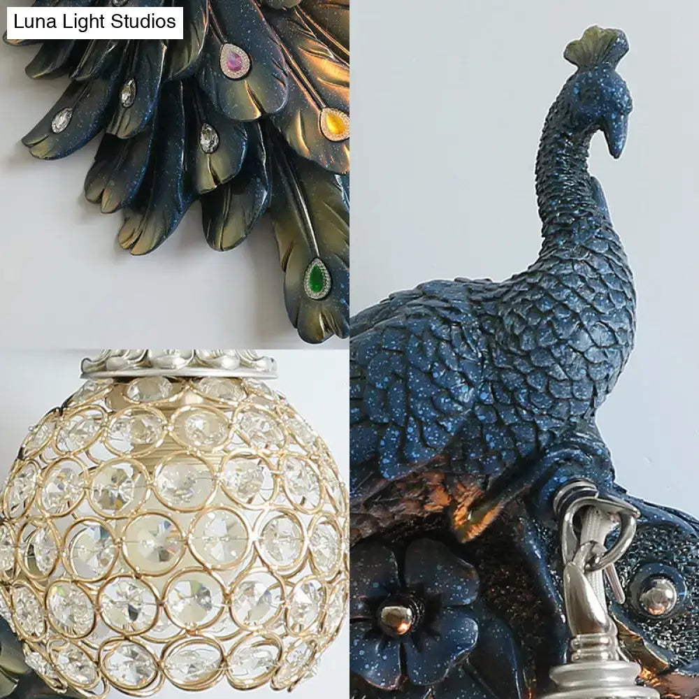 Peacock blue and gold wall sconce with blue glittery peacock feathers and clear crystal dome shade for bedroom lighting