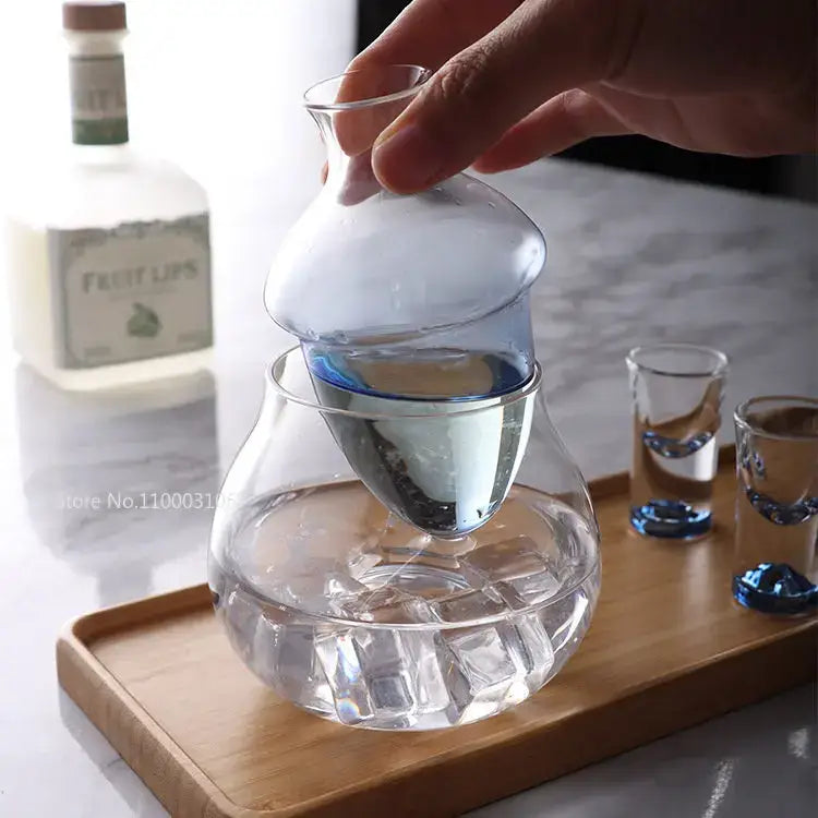 Clear glass pear shaped wine decanter and ice jug set with bulbous body and integrated ice jug design for chilling beverages