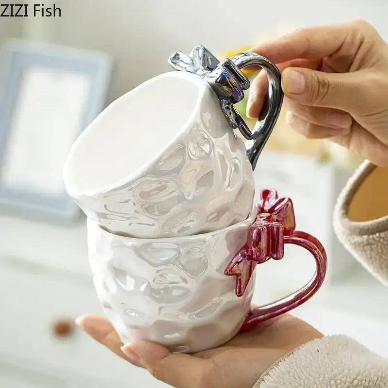 White ceramic bowknot handle porcelain mugs with textured surfaces and red and silver decorbites bowknot handles by zizi fish