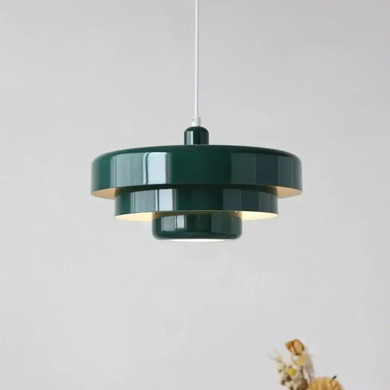 Dark green tiered pendant lighting with glossy finish and warm glow in Bauhaus style retro pendant lamp design
