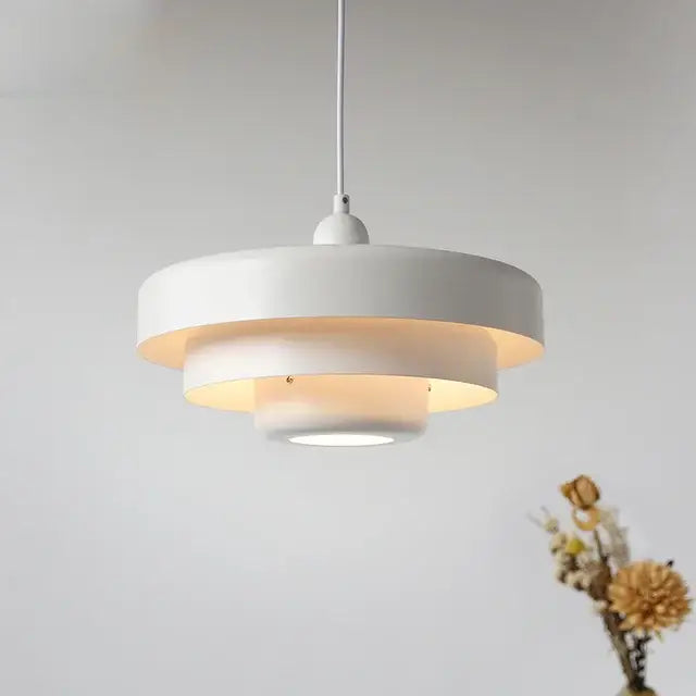 White tiered pendant lighting bauhaus style with modern minimalist design and warm ambient glow for indoor use