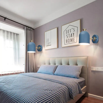 Blue dome-shaped wall light sconce lamp with brass cup shade accents designed for dining room use